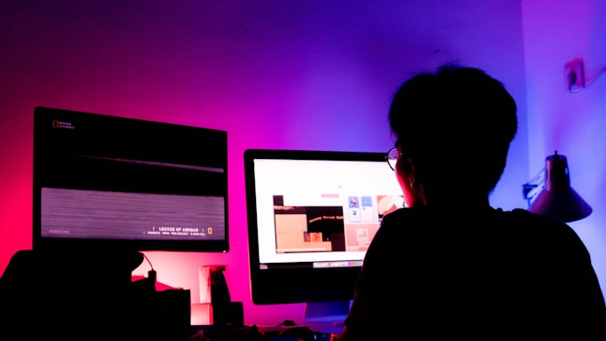 A sleek portrait of thejashree working late in a neon-lit studio, surrounded by multiple screens displaying digital marketing dashboards.