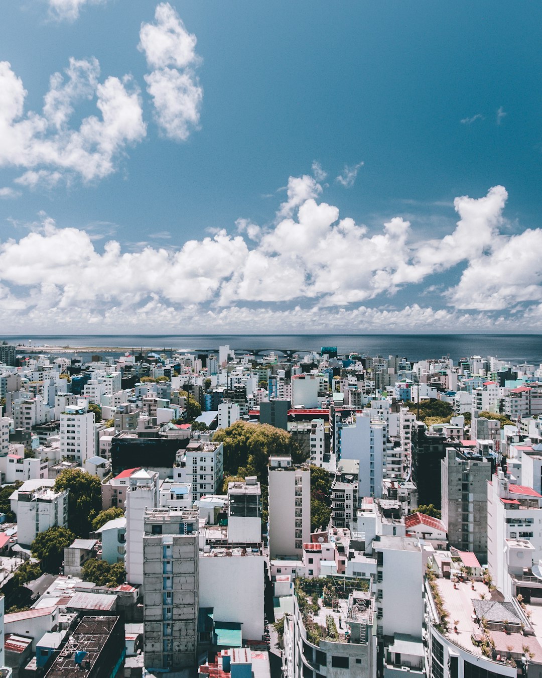 white clouds over city buildings during daytime