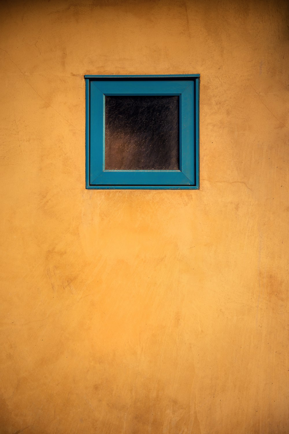 brown wooden frame on white wall