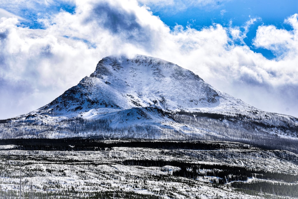 snow covered mountain under cloudy sky during daytime