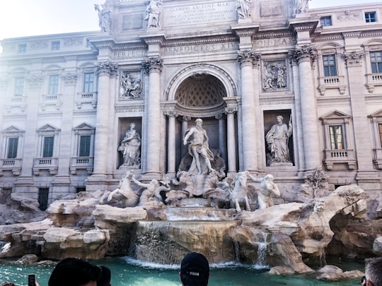 people in front of white concrete building during daytime in Trevi Fountain Italy