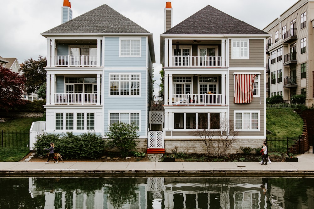 white and red concrete building near body of water during daytime