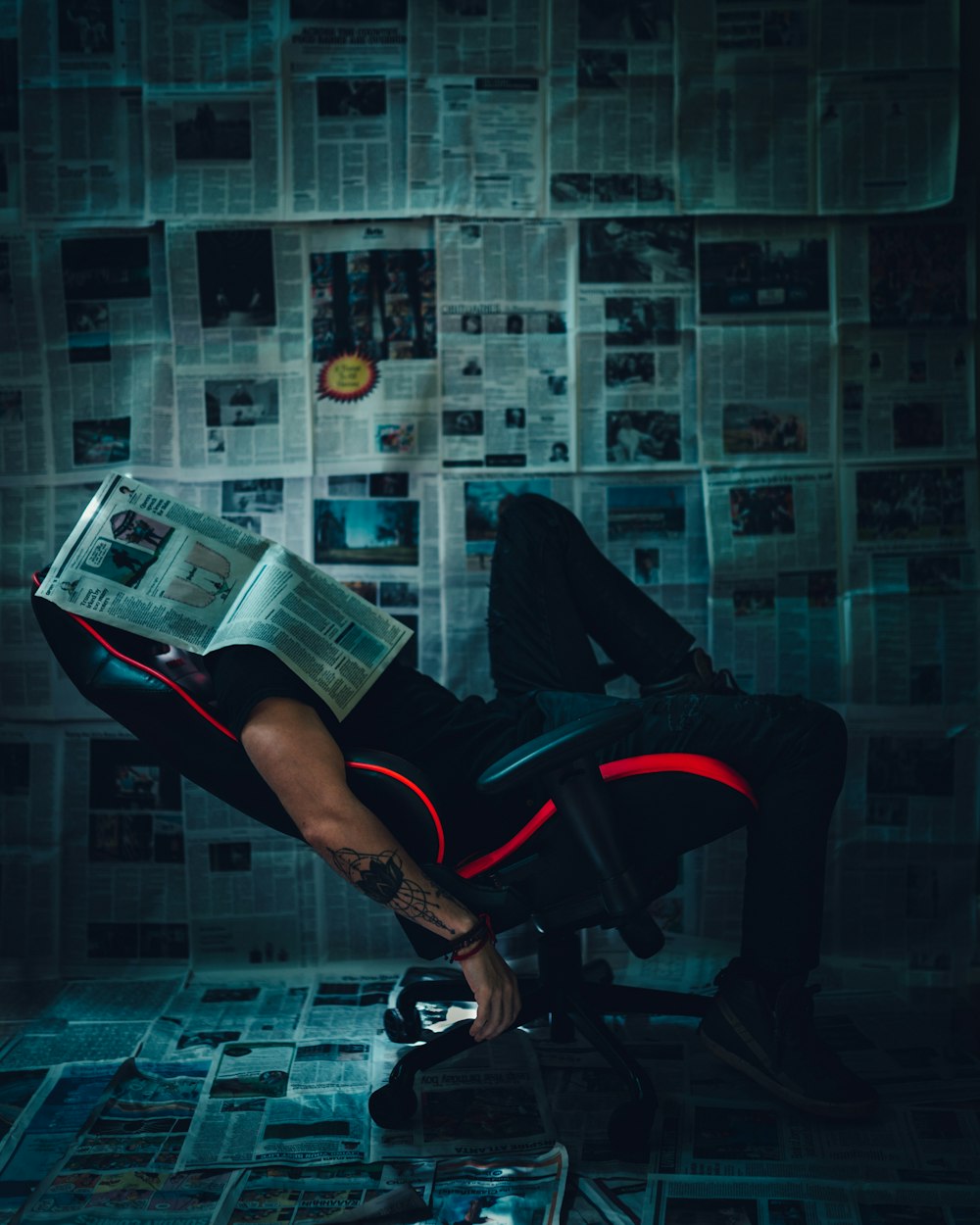man in black pants reading book