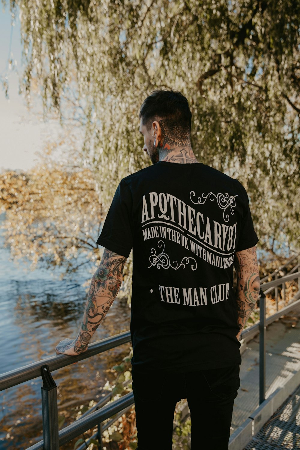 Man in black and white crew neck t-shirt standing beside railings near  river during daytime photo – Free Mens fashion Image on Unsplash