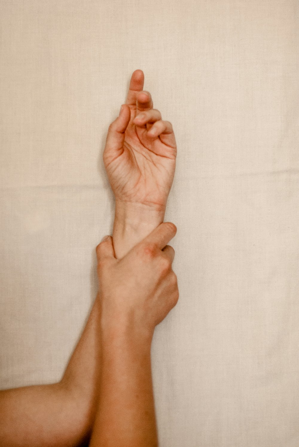 persons right foot on white textile