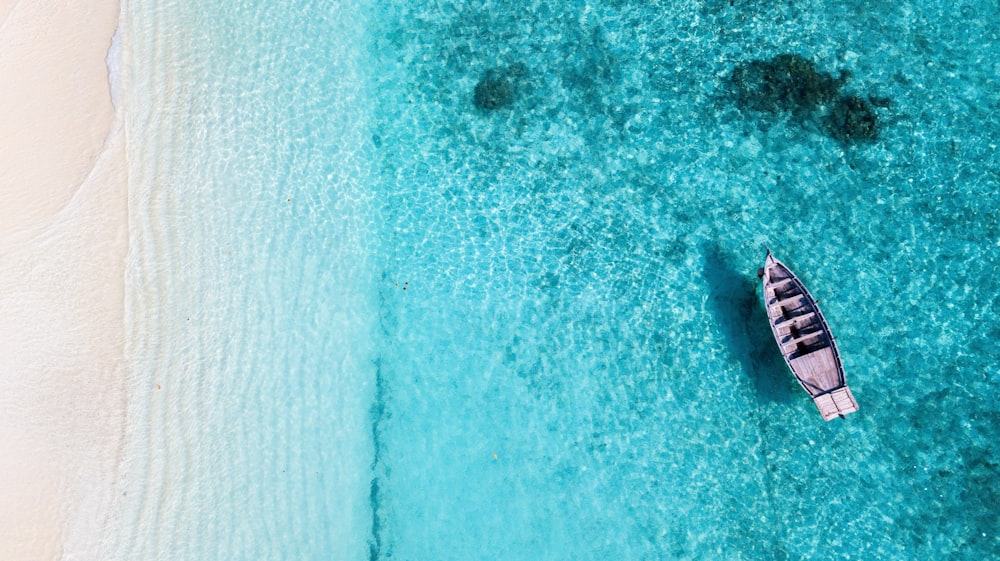 aerial view of person in white shirt on body of water during daytime