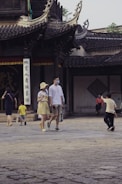Modern Chinese medical university building with students walking in front