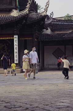 Modern Chinese medical university building with students walking in front