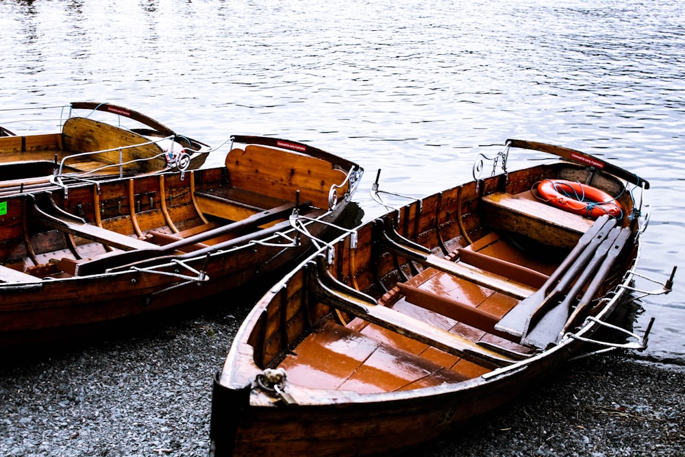 brown wooden boat on body of water during daytime