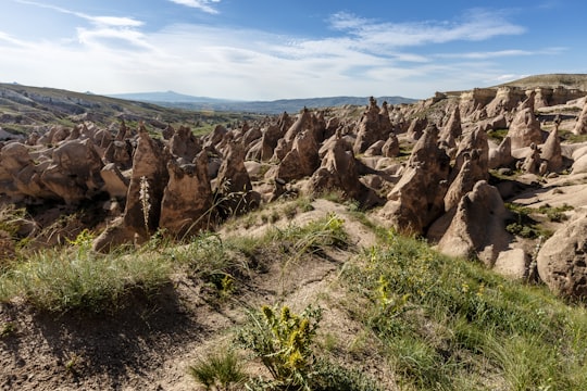 brown rock formation under blue sky during daytime in Kapadokya Turkey