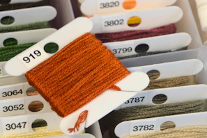 brown and white towel on white plastic rack