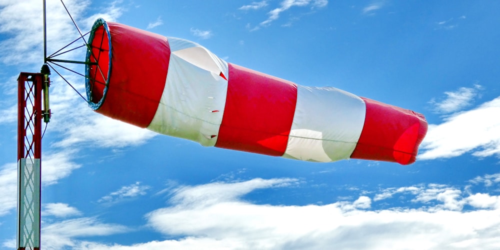 red and white flag under blue sky during daytime