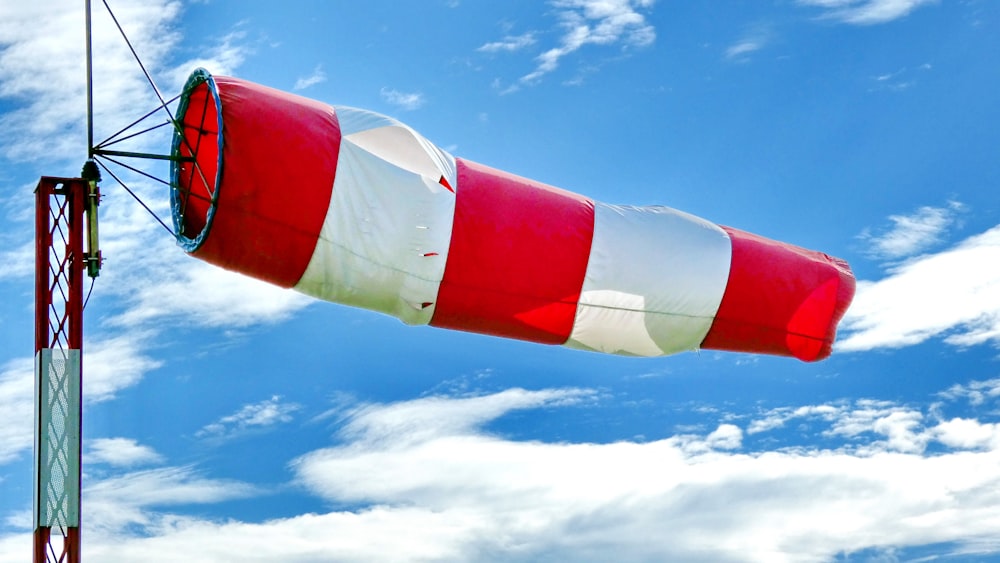 red and white flag under blue sky during daytime