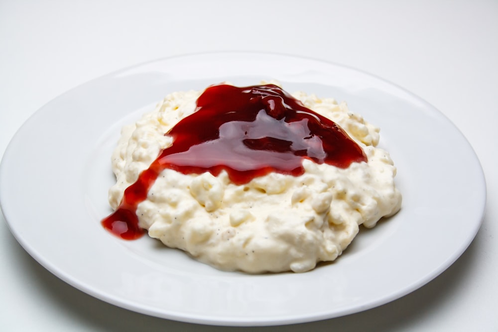white rice with red sauce on white ceramic plate