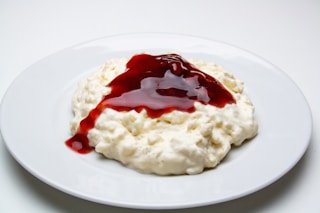 white rice with red sauce on white ceramic plate