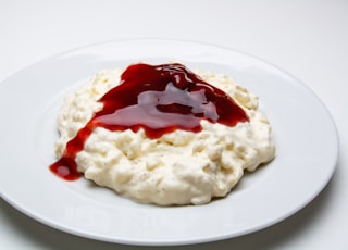 white rice with red sauce on white ceramic plate