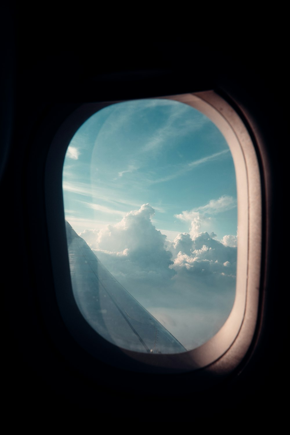 airplane window view of clouds during daytime