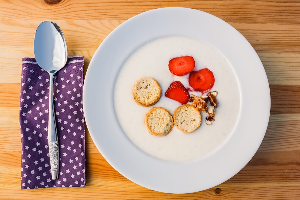 sliced strawberry and bread on white ceramic plate