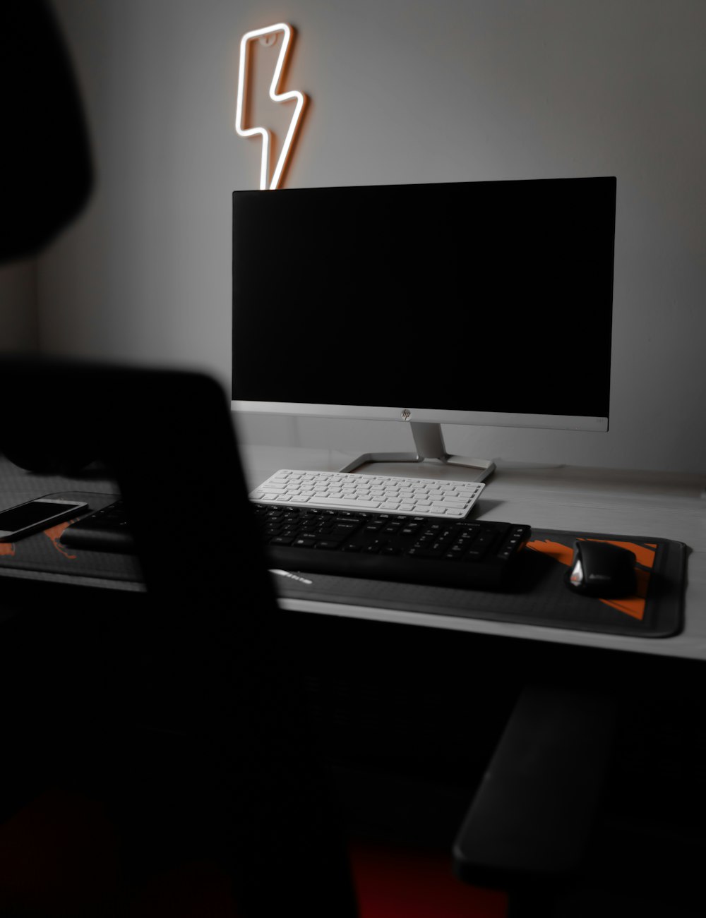 black flat screen computer monitor and keyboard on black wooden desk