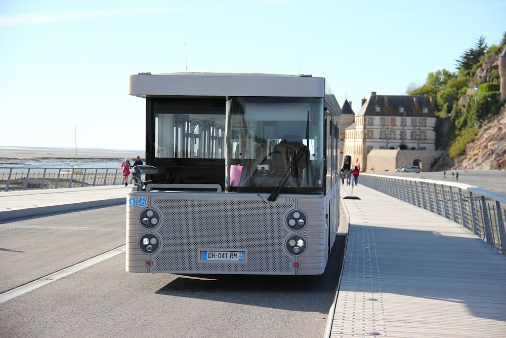 blue and white bus on road during daytime