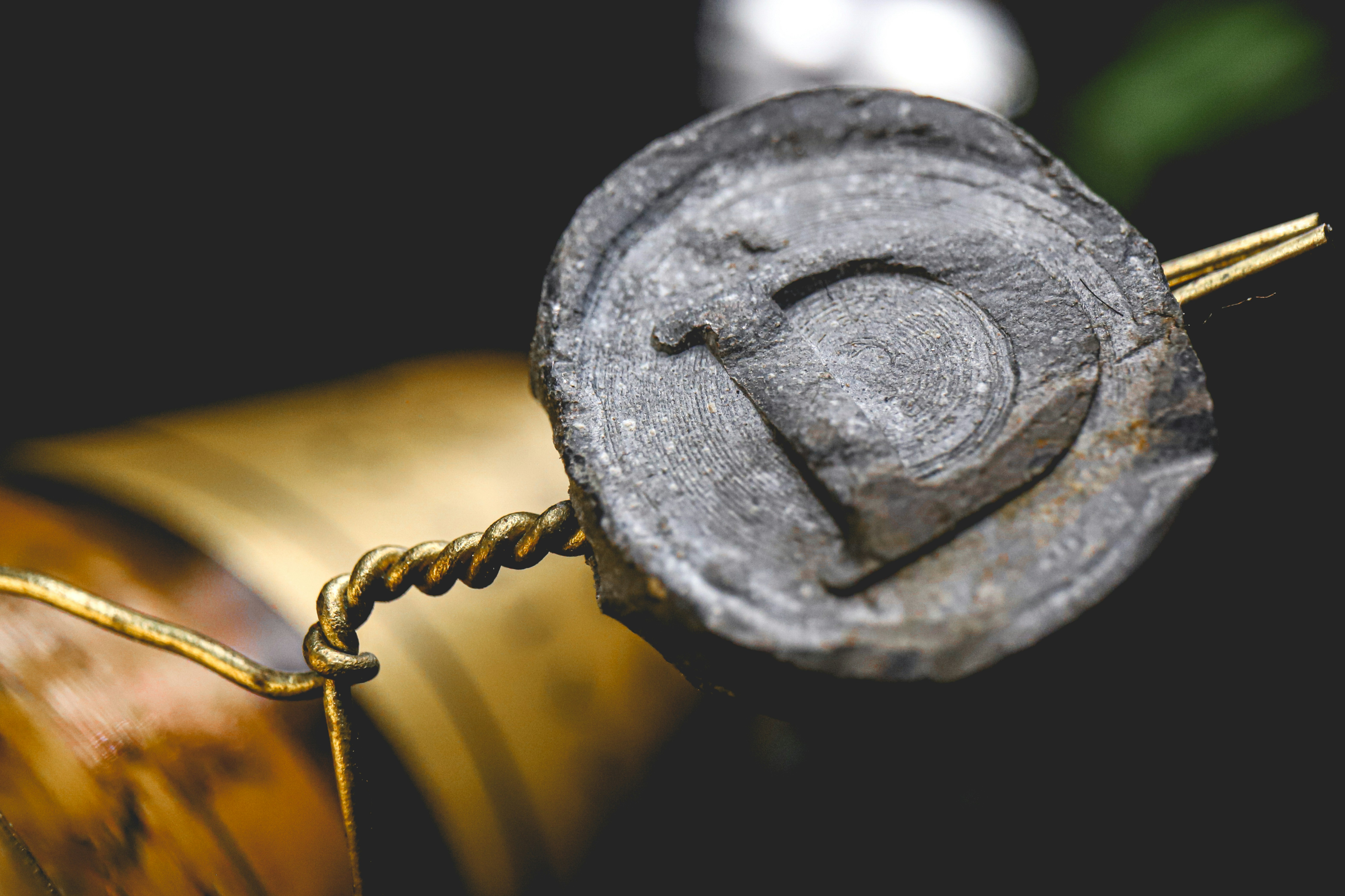 black metal round padlock on brown rope