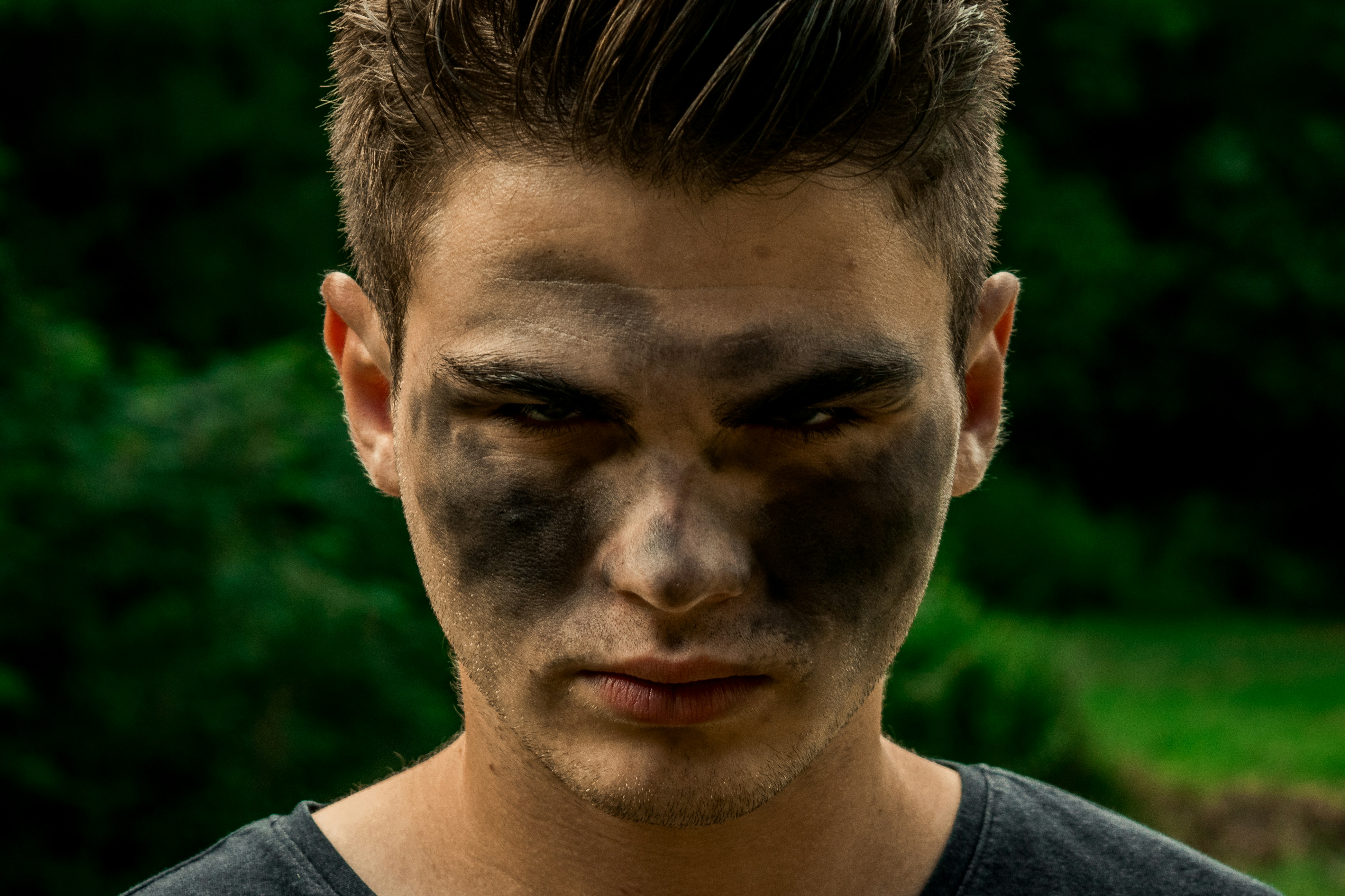 a young man with a black face and black makeup
