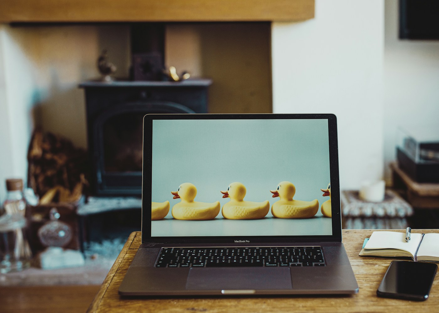 macbook pro on brown wooden table