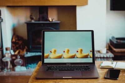 macbook pro on brown wooden table remote google meet background