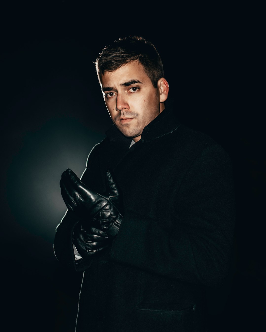 man in black jacket and black leather gloves