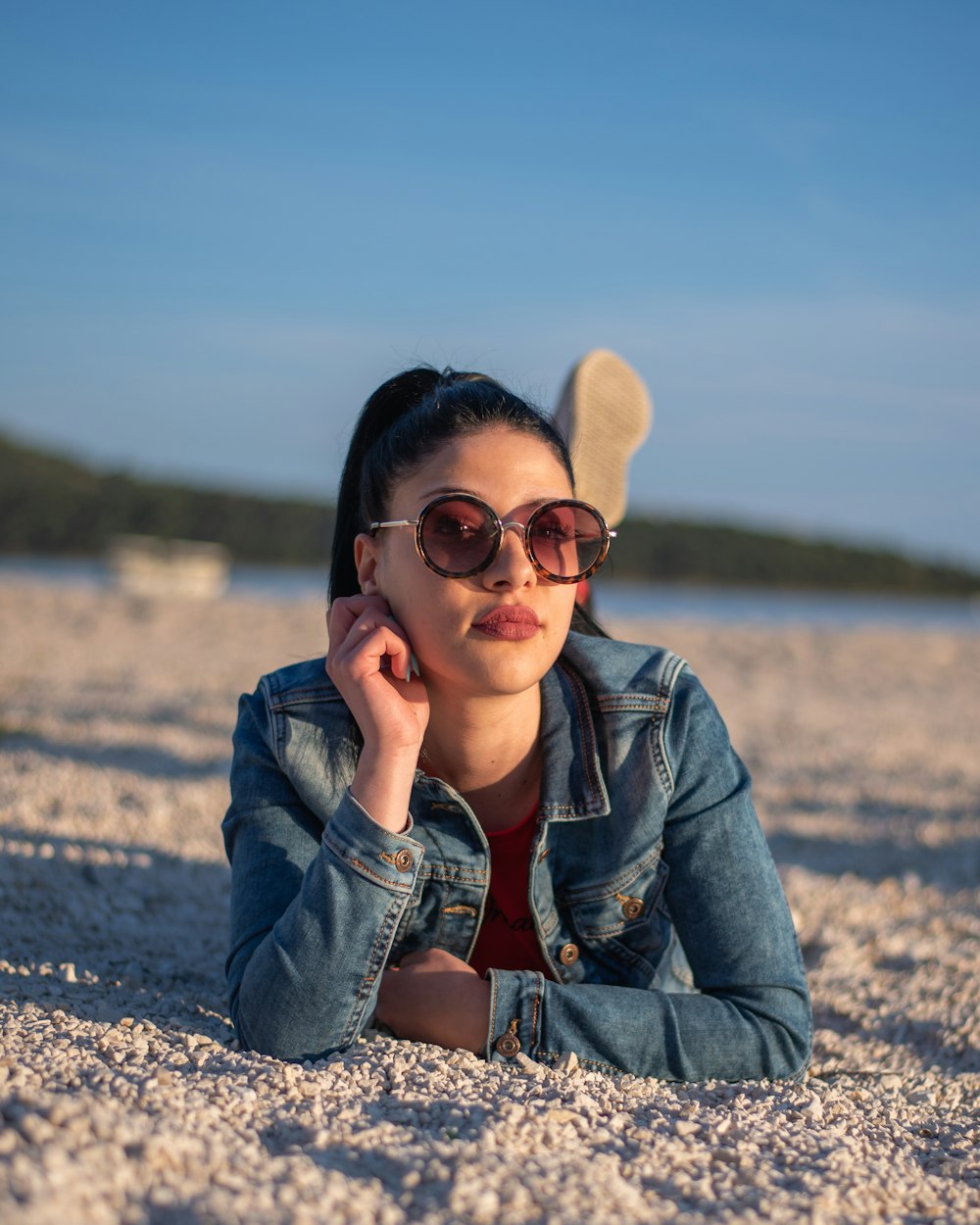 woman in blue denim jacket wearing black framed eyeglasses