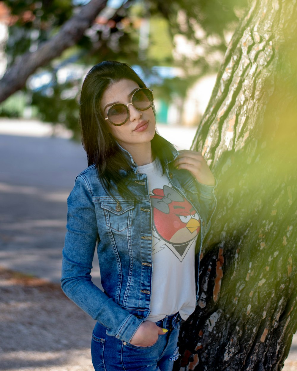 Woman in blue denim jacket and white shirt standing beside tree during  daytime photo – Free Clothing Image on Unsplash