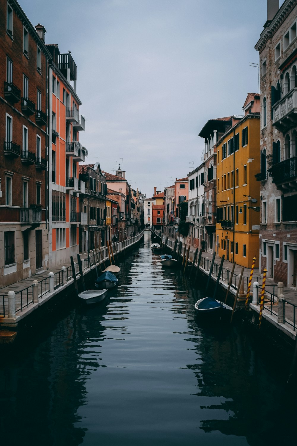 boat on river between buildings during daytime