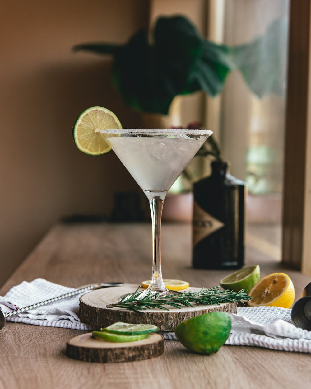 clear martini glass with sliced lemon on brown wooden table