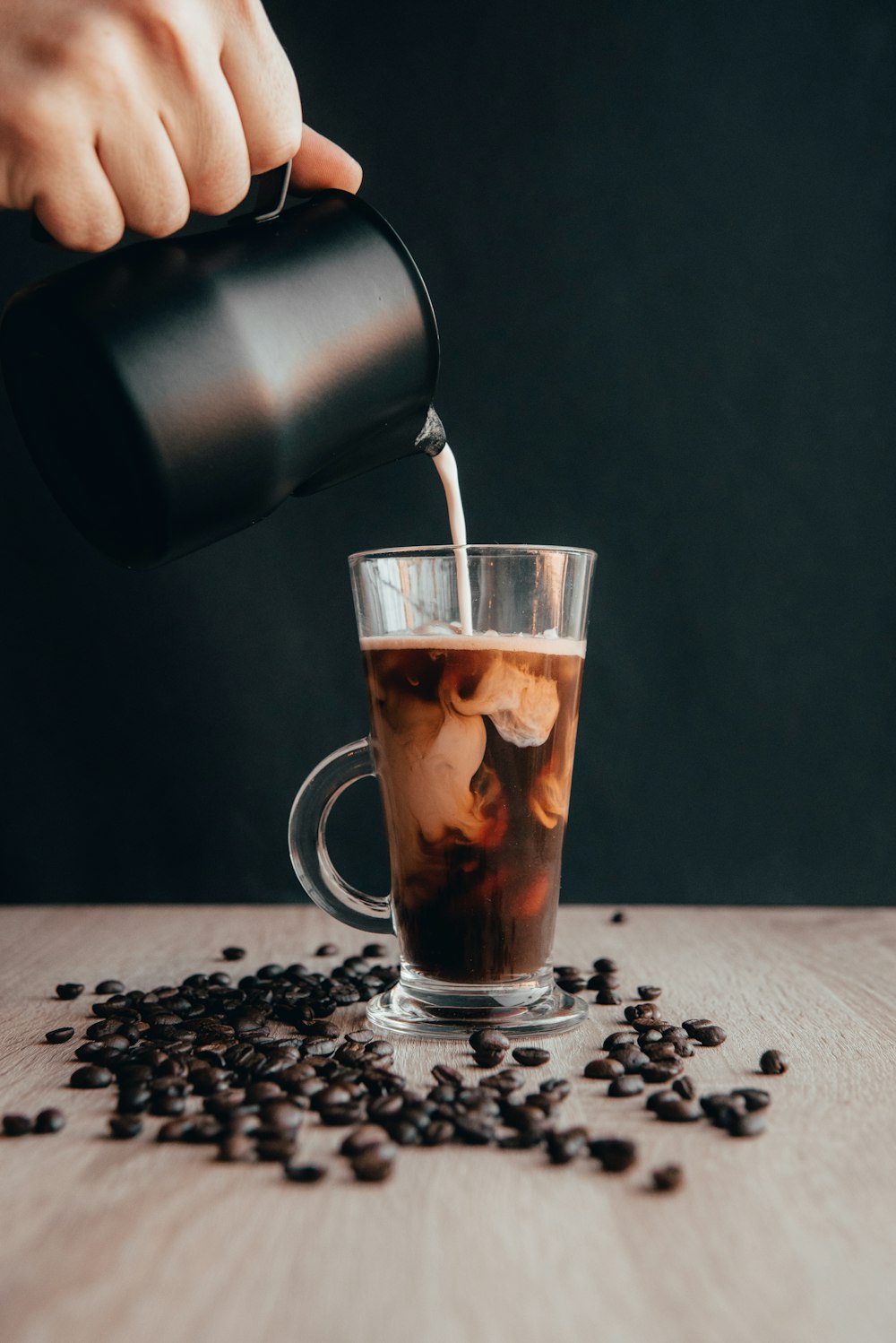 clear glass mug with coffee beans