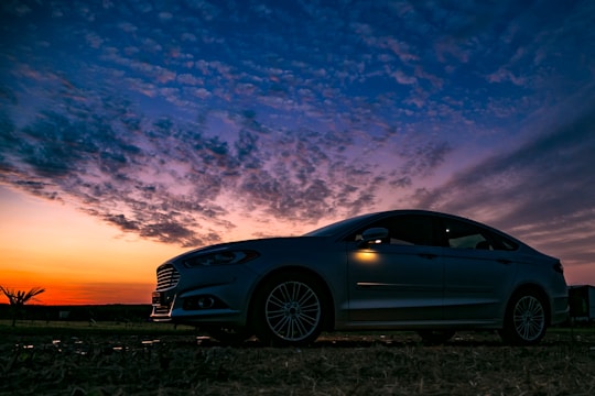 blue bmw m 3 coupe on brown field under blue and white cloudy sky during daytime