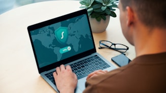 person using macbook pro on white table