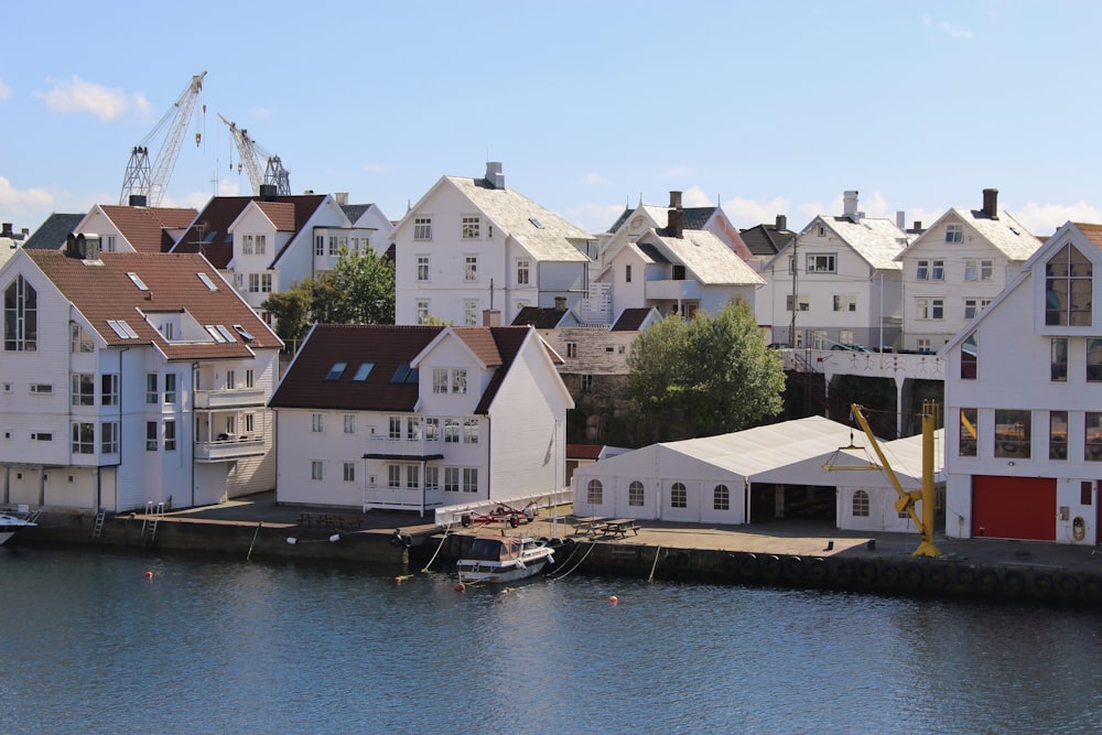 white and brown houses beside body of water during daytime