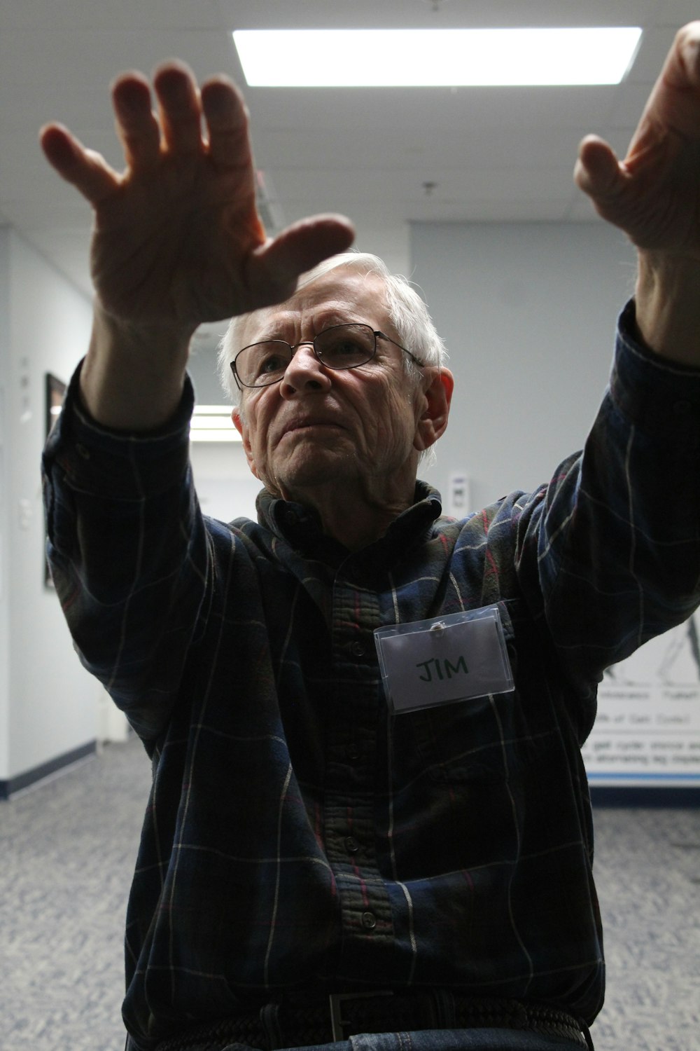 man in black jacket raising his right hand