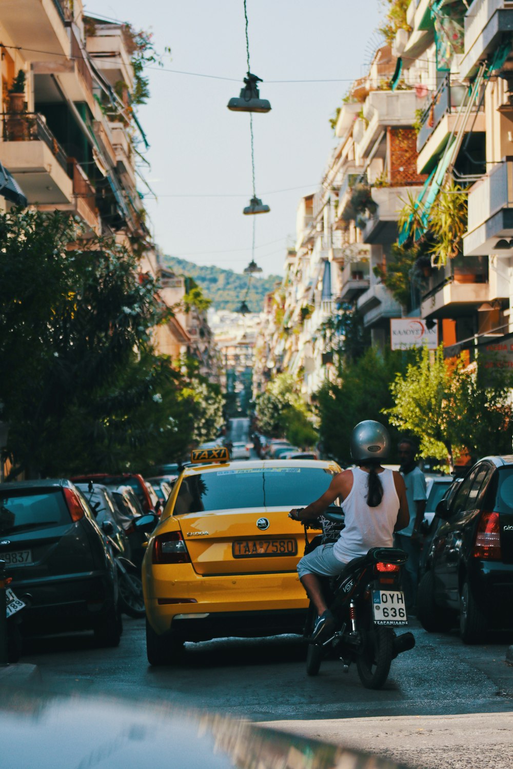 man in black helmet riding yellow car during daytime