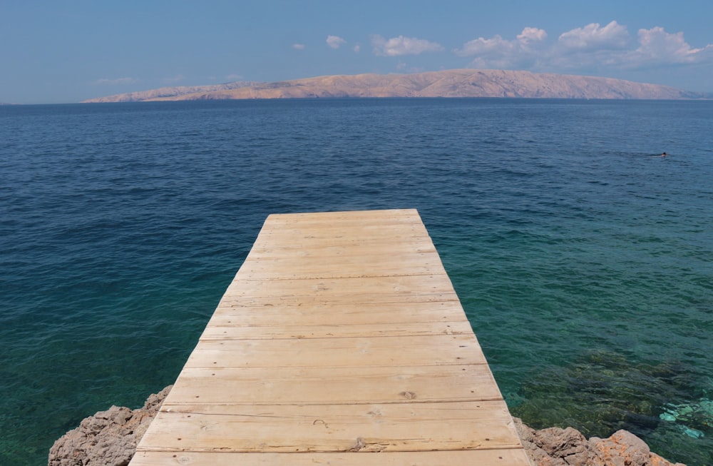 a wooden dock extending out into the ocean