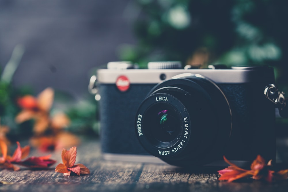 black and white canon camera on gray concrete floor