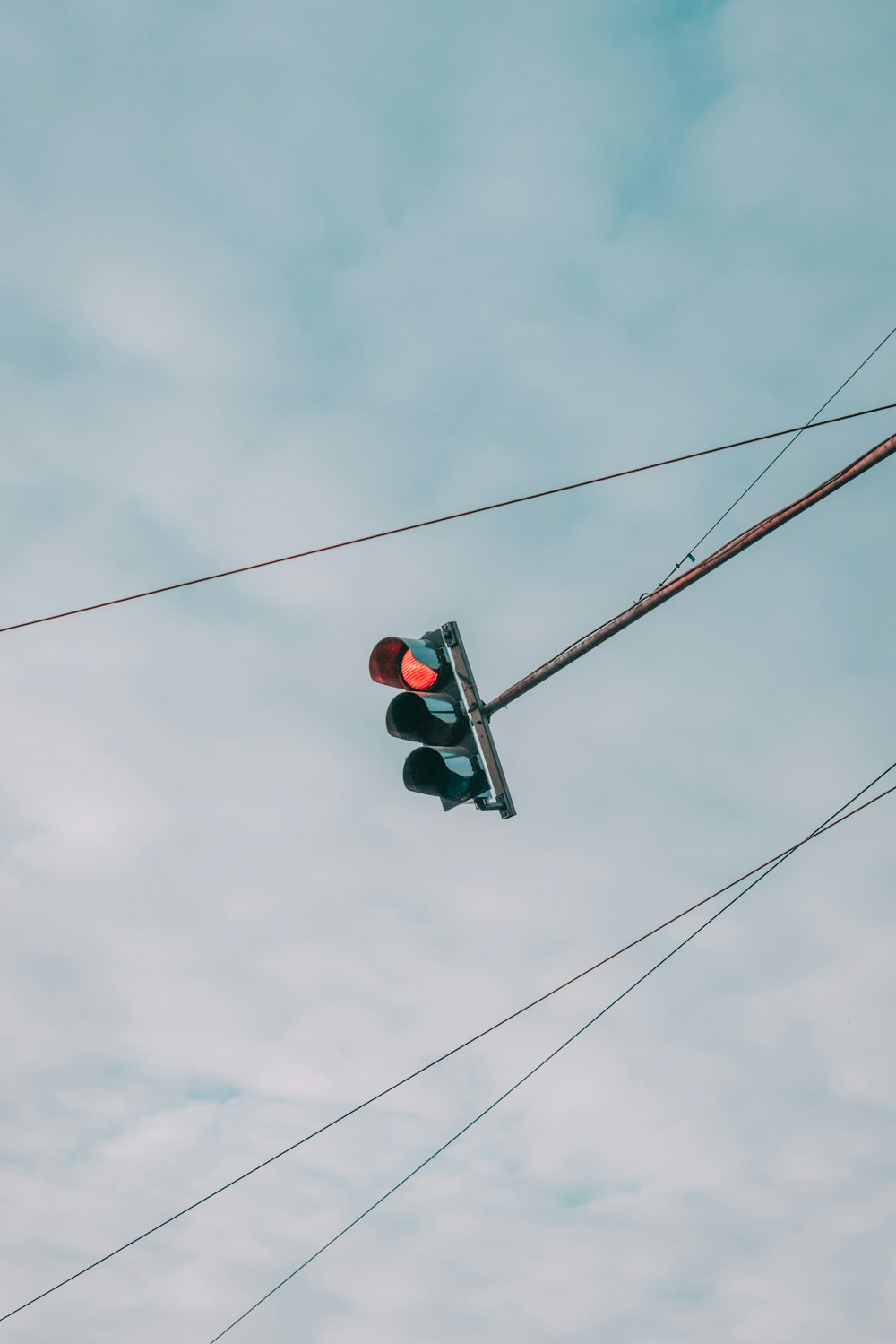 traffic light under gray cloudy sky