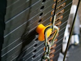 Technician performing maintenance on a weight machine.