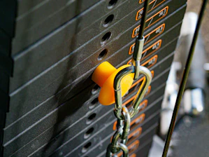 Close-up of hands adjusting weights on a strength training machine.