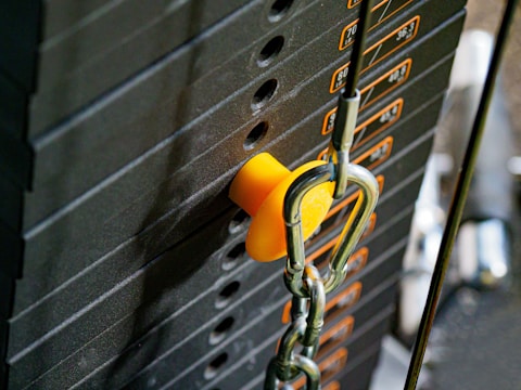 Technician performing maintenance on a weight machine.
