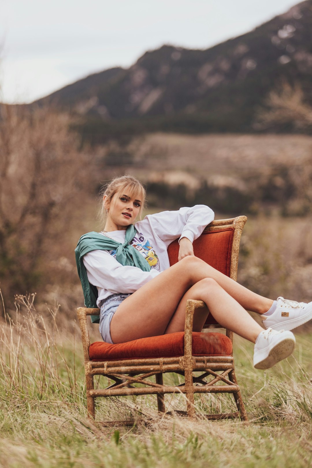 girl in white shirt sitting on brown wooden armchair