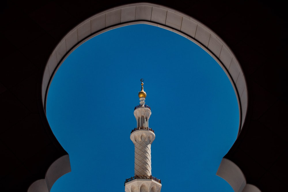 white and gold concrete building under blue sky during daytime