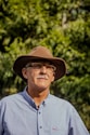 man in gray button up shirt wearing brown fedora hat