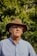 man in gray button up shirt wearing brown fedora hat