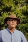man in gray button up shirt wearing brown fedora hat